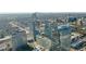 Impressive aerial view featuring a modern, glass skyscraper with a geometric design in a bustling urban landscape at 3325 Piedmont Ne Rd # 2702, Atlanta, GA 30305