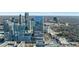 Panoramic aerial view of a modern city skyline, featuring a sleek glass skyscraper and dense surrounding buildings at 3325 Piedmont Ne Rd # 2702, Atlanta, GA 30305