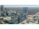 Expansive aerial view of a city with a modern glass skyscraper, showcasing the surrounding urban landscape and skyline at 3325 Piedmont Ne Rd # 2702, Atlanta, GA 30305