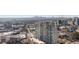 A high-rise building surrounded by city views, complete with nearby buildings and lush green trees at 3325 Piedmont Ne Rd # 2702, Atlanta, GA 30305