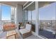 Relaxing balcony with comfortable seating and stunning city views through expansive sliding glass doors at 3325 Piedmont Ne Rd # 2702, Atlanta, GA 30305