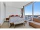 Bright bedroom with floor-to-ceiling windows offering panoramic city views and contemporary furnishings at 3325 Piedmont Ne Rd # 2702, Atlanta, GA 30305