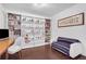 Bright bedroom with beautiful hardwood floors, stylish sofa and expansive built-in bookshelves at 3325 Piedmont Ne Rd # 2702, Atlanta, GA 30305