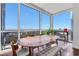Open dining space with large windows and city views, next to a plant in natural light at 3325 Piedmont Ne Rd # 2702, Atlanta, GA 30305