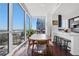 Cozy dining area showcasing modern furnishings, floor-to-ceiling windows, and an open view of the kitchen at 3325 Piedmont Ne Rd # 2702, Atlanta, GA 30305
