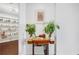 Inviting hallway featuring plants and a violin, leading to a bright room with a built-in bookshelf at 3325 Piedmont Ne Rd # 2702, Atlanta, GA 30305