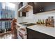Modern kitchen featuring stainless steel oven, white counters, dark cabinets and natural light from large windows at 3325 Piedmont Ne Rd # 2702, Atlanta, GA 30305