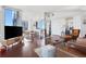 Bright, open-concept living space with hardwood floors, modern furniture, and floor-to-ceiling windows offering city views at 3325 Piedmont Ne Rd # 2702, Atlanta, GA 30305