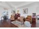 Spacious living room featuring hardwood floors, comfortable seating, and access to kitchen, bedroom and balcony at 3325 Piedmont Ne Rd # 2702, Atlanta, GA 30305