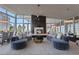 Elegant living room with plush sofas, a fireplace, modern lighting, and floor-to-ceiling windows at 3325 Piedmont Ne Rd # 2702, Atlanta, GA 30305