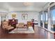 Hardwood floored living room with plenty of comfortable seating and access to an adjacent bedroom and balcony at 3325 Piedmont Ne Rd # 2702, Atlanta, GA 30305
