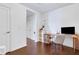 Home office featuring hardwood floors, a sleek minimalist desk setup and bright, white walls at 3325 Piedmont Ne Rd # 2702, Atlanta, GA 30305