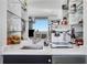 Modern wet bar with marble counters, glass shelving, and an espresso machine, perfect for entertaining guests at 3325 Piedmont Ne Rd # 2702, Atlanta, GA 30305