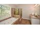 Elegant bathroom with a soaking tub, shower, and granite vanity at 658 Wolfs Bane Nw Dr, Acworth, GA 30102