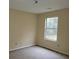 Simple bedroom with large window and neutral walls at 1119 Oakwood Manor Ct, Decatur, GA 30032