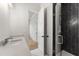 Modern bathroom with a glass shower door, black herringbone tile, and a white countertop at 122 Owens Mill Pl, Canton, GA 30115