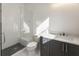 Bathroom with walk in shower with glass door, and a sleek white vanity with modern fixtures at 122 Owens Mill Pl, Canton, GA 30115