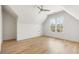 A bright, spacious bedroom featuring hardwood floors, a ceiling fan, and a large window at 122 Owens Mill Pl, Canton, GA 30115
