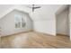 A bright, spacious bedroom featuring hardwood floors, a ceiling fan, and a large window at 122 Owens Mill Pl, Canton, GA 30115