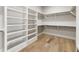Spacious walk-in closet with built-in shelves and hanging rods at 122 Owens Mill Pl, Canton, GA 30115