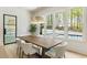 Bright dining room with wood floors, large windows, and a wood table at 122 Owens Mill Pl, Canton, GA 30115