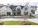 Stunning two-story home with white brick exterior and circular driveway at 122 Owens Mill Pl, Canton, GA 30115