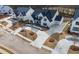 Impressive new construction home featuring a manicured lawn and expansive driveway on a tree-lined street at 122 Owens Mill Pl, Canton, GA 30115