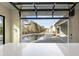 Open outdoor bar providing views of the luxurious pool, backyard, and modern white farmhouse at 122 Owens Mill Pl, Canton, GA 30115
