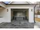 Spacious outdoor bar featuring a glass garage door, stylish shelving, and sleek gray countertops at 122 Owens Mill Pl, Canton, GA 30115