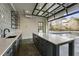 Gorgeous outdoor bar space with gray counters, a sink, and views of the beautiful backyard pool at 122 Owens Mill Pl, Canton, GA 30115
