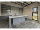 Well-appointed outdoor bar boasts an open-air design, black shelving, and elegant stone tile flooring at 122 Owens Mill Pl, Canton, GA 30115