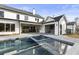 Stunning backyard pool with a modern white farmhouse and outdoor grilling area in a new construction home at 122 Owens Mill Pl, Canton, GA 30115