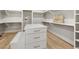 Large walk-in closet with custom built-ins and bench at 122 Owens Mill Pl, Canton, GA 30115