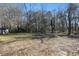 Large backyard with mature trees and grassy area at 1512 Flat Shoals Rd, Atlanta, GA 30349