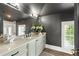 Modern bathroom with a gray vanity and a large mirror at 211 N Esplanade, Alpharetta, GA 30009