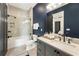 Modern bathroom with navy blue walls and a walk-in shower at 211 N Esplanade, Alpharetta, GA 30009