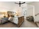 Upstairs bedroom with a wooden bed frame and sitting area at 211 N Esplanade, Alpharetta, GA 30009