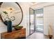Bright entryway with a glass door and a circular mirror at 211 N Esplanade, Alpharetta, GA 30009