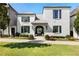 Elegant two-story home with gray metal roof and landscaping at 211 N Esplanade, Alpharetta, GA 30009