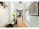 Long hallway with exposed brick and hardwood floors at 211 N Esplanade, Alpharetta, GA 30009