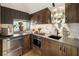 Modern kitchenette featuring wood cabinets and built-in appliances at 211 N Esplanade, Alpharetta, GA 30009