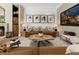 Spacious living room featuring a cozy fireplace and large TV at 211 N Esplanade, Alpharetta, GA 30009