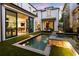 Backyard pool and patio with illuminated water feature at night at 211 N Esplanade, Alpharetta, GA 30009