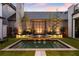 Evening view of a tranquil pool and landscaped backyard at 211 N Esplanade, Alpharetta, GA 30009