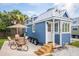 Charming blue tiny house on wheels with a covered porch and outdoor seating area at 254 Elizabeth Ne St, Atlanta, GA 30307