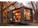 Modern tiny home with large windows and wood siding, nestled amongst autumn trees at 254 Elizabeth Ne St, Atlanta, GA 30307