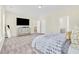Bright bedroom featuring a large TV and ensuite bathroom at 9026 Jim Purcell Dr, Covington, GA 30014