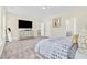 Bright bedroom featuring a large TV and ensuite bathroom at 9026 Jim Purcell Dr, Covington, GA 30014