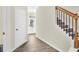 Bright entryway with wood-look flooring and staircase at 9026 Jim Purcell Dr, Covington, GA 30014