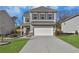 Two story house with a two car garage and landscaped yard at 9026 Jim Purcell Dr, Covington, GA 30014